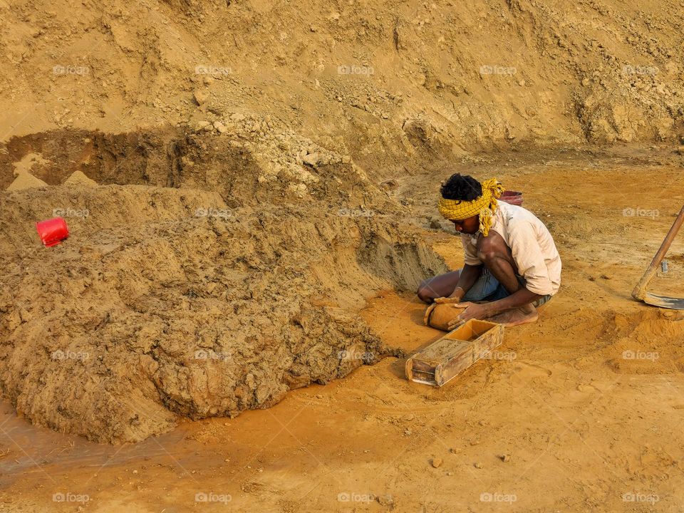 Man making mould and bricks