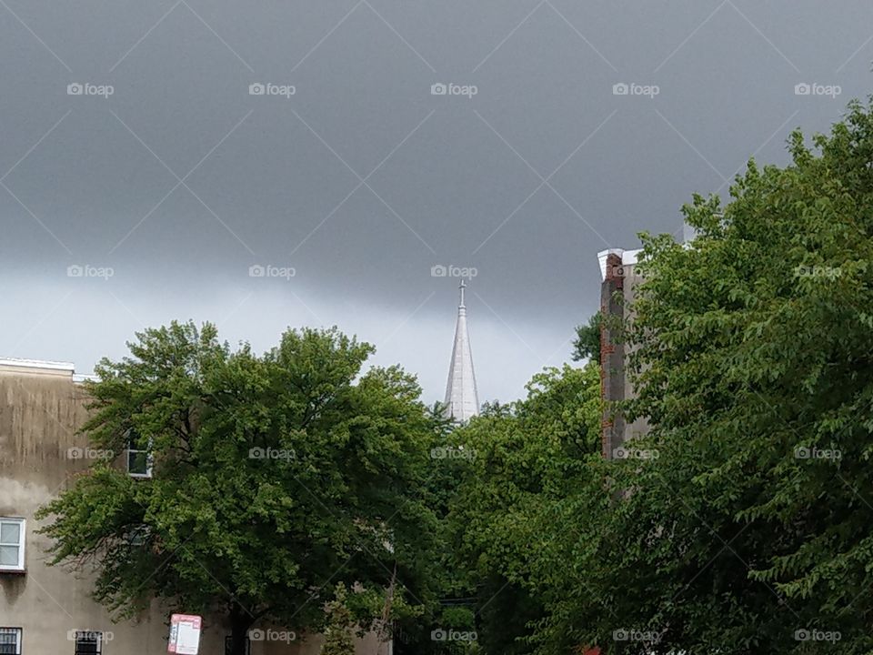 The clouds coming over  Church steeple before the rain storm hit in Baltimore