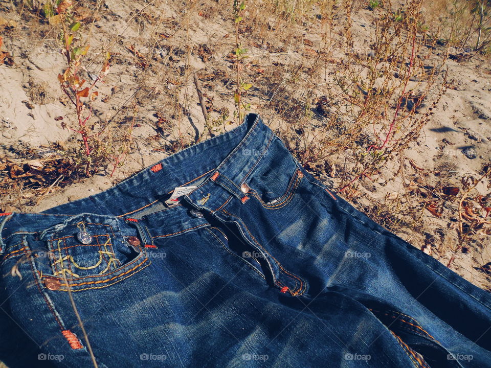 jeans lie on sand