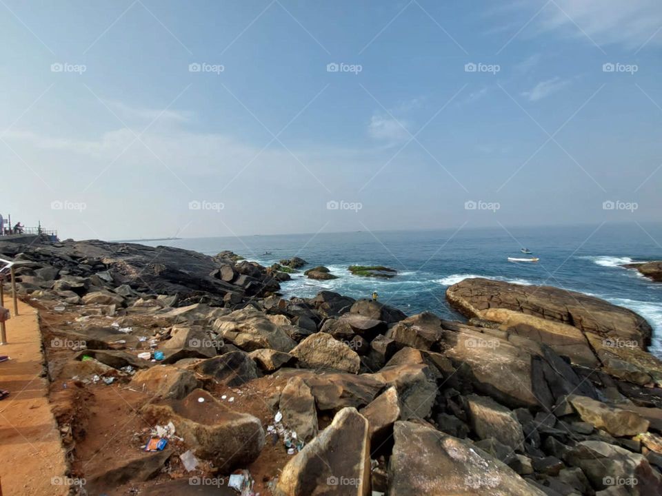 Looks like nature is playing hide and seek with the trash in the water! Let's hope the rocks win this round and keep the beach clean and beautiful. ποΈπ