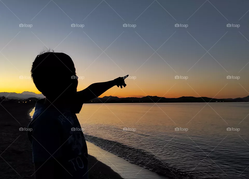 Little boy looking at the sunset