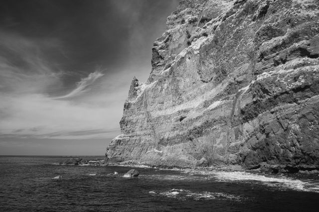 A black and white image of a jagged cliff face on the island of Madeira during spring 