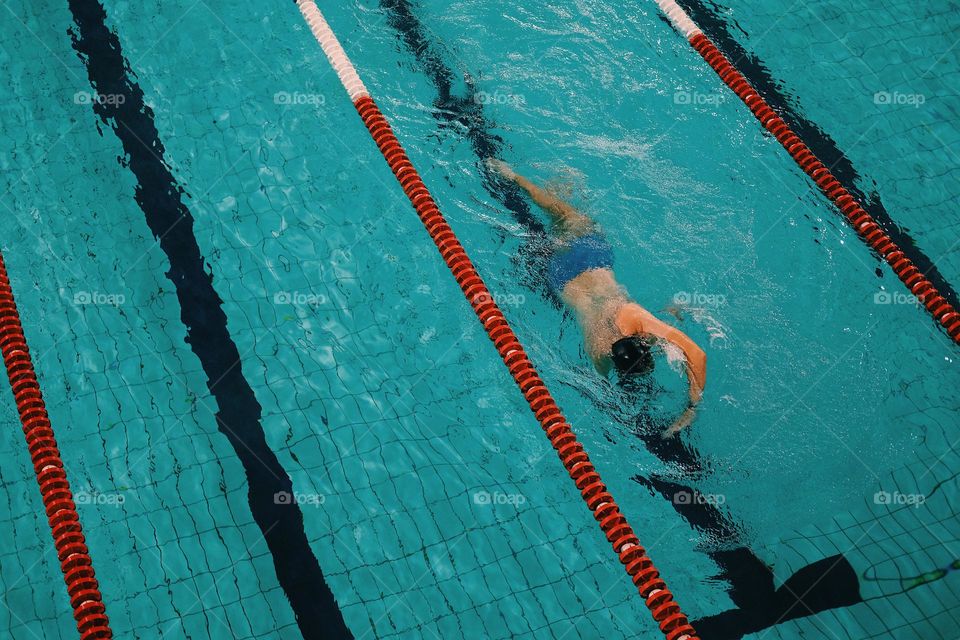 A man is swimming in the pool