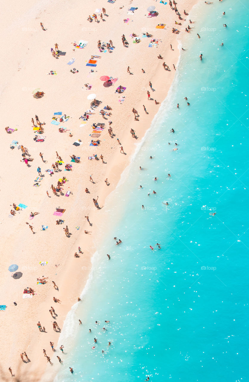 Aerial Famous Shipwreck Beach At Zakynthos Island Greece. People enjoying their vacation at the beach.