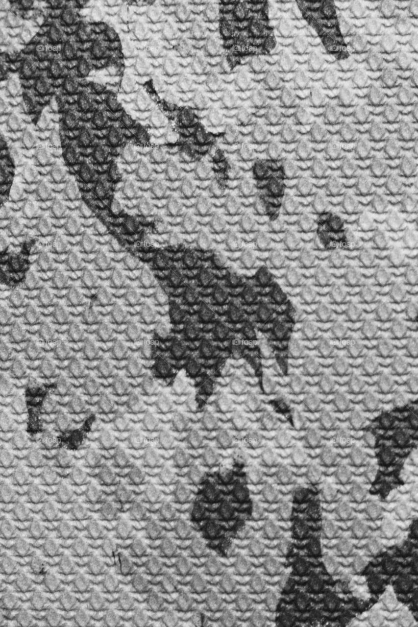 Creative Textures - closeup of a black and gray camouflage rubber pad  top surface 