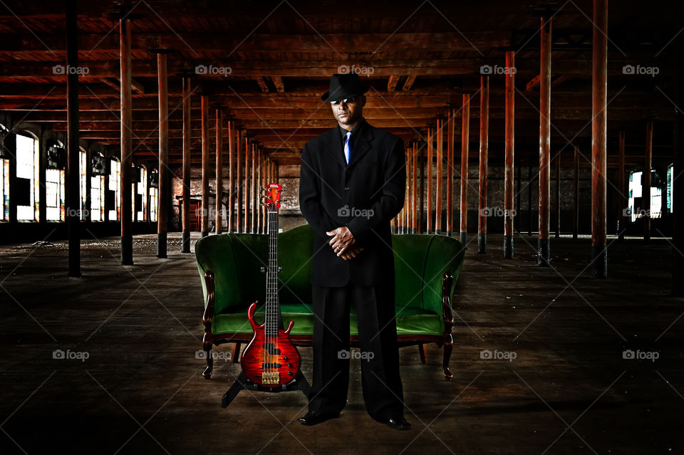Musician with guitar. Image of a musician with guitar in old loft