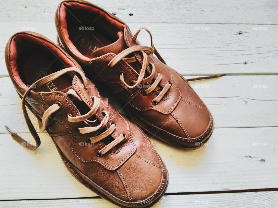 Brown leather men's shoes on a white background