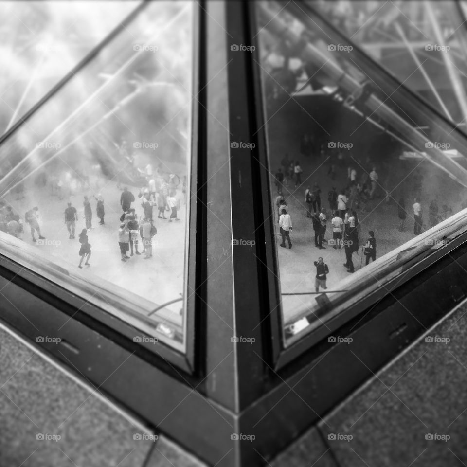 Through the looking glass, at one of the vertices of the Louvre glass pyramid in Paris. I wanted to avoid the tourists in the foreground, but captured those within the art gallery in doing so! Love a bit of symmetry also. 