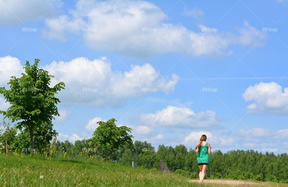 girl running nature landscape view from the ground