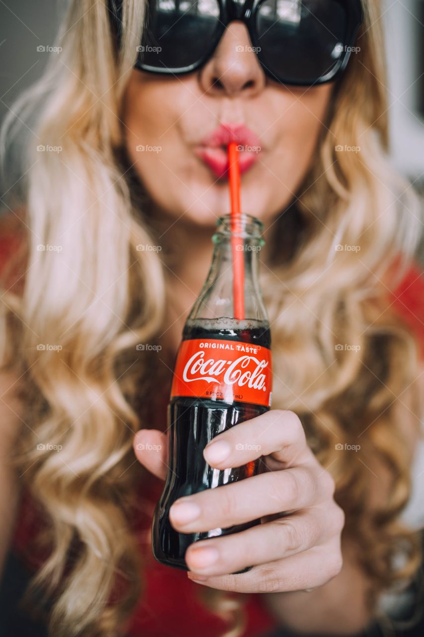 Girl drinking Coca Cola 