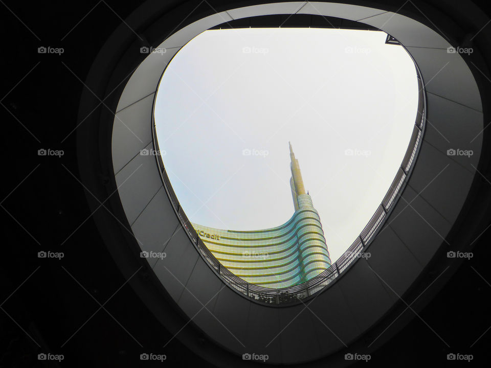 top of the unicredit's skyscraper seen from a hole,Milan.Italy