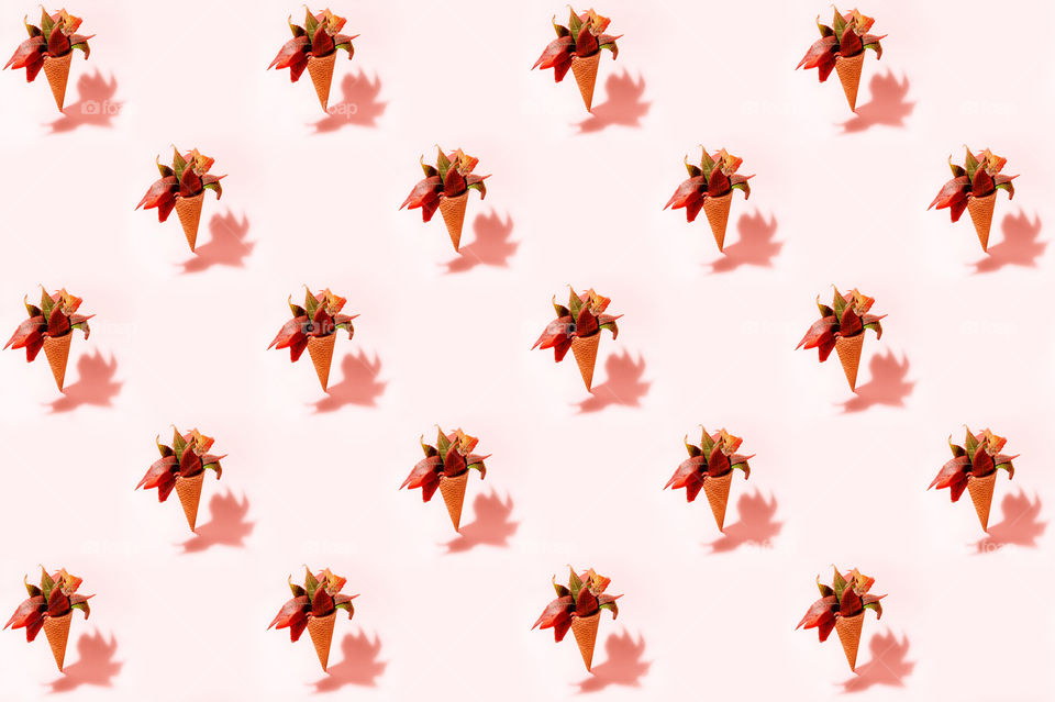 Creative pattern of ice cream cone with autumn leaves