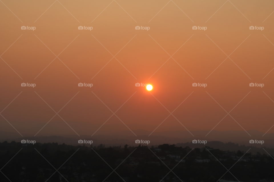 Sunset on a red smoky sky