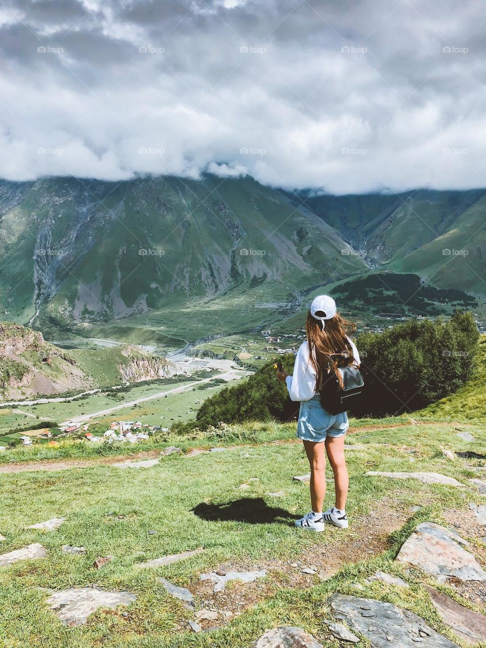 Young woman with backpack enjoying mountain landscape