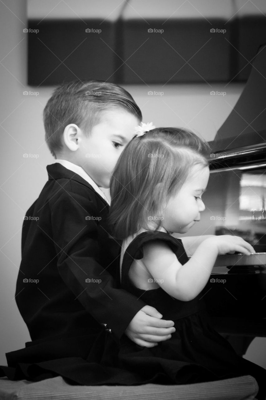Little Brother and sister playing piano