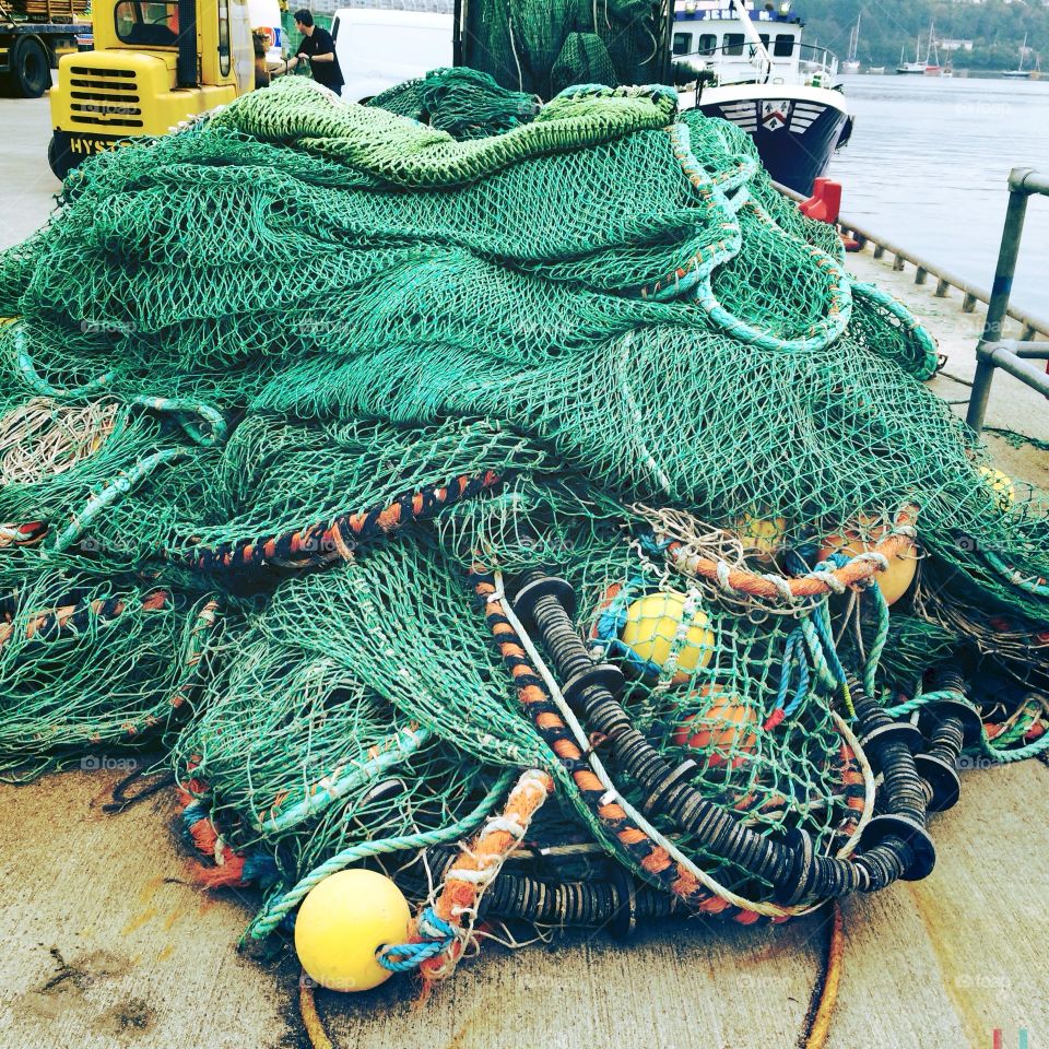 Pile of fish nets on a dock 