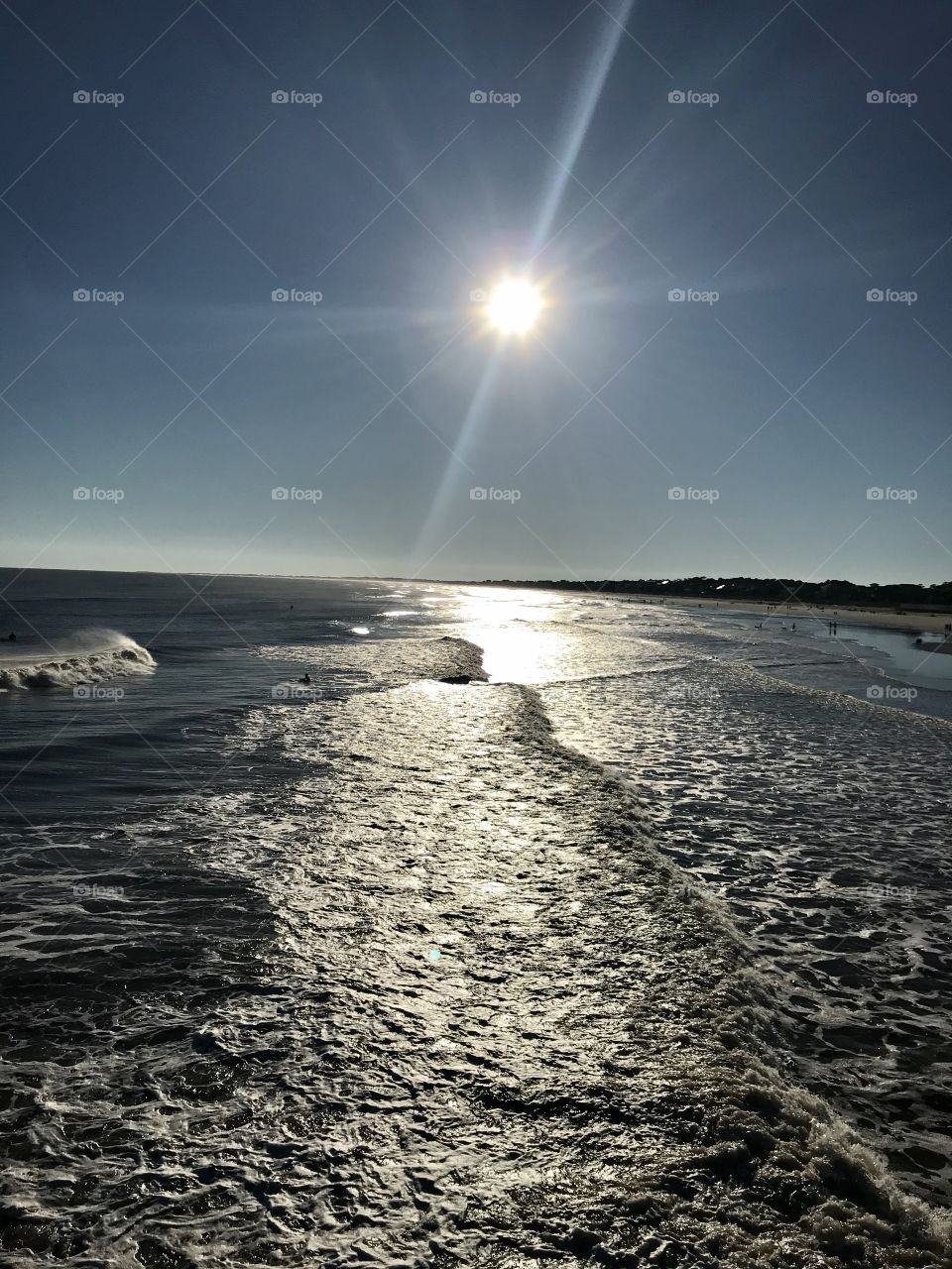 Watching the sunset and waves break at the beach from the pier