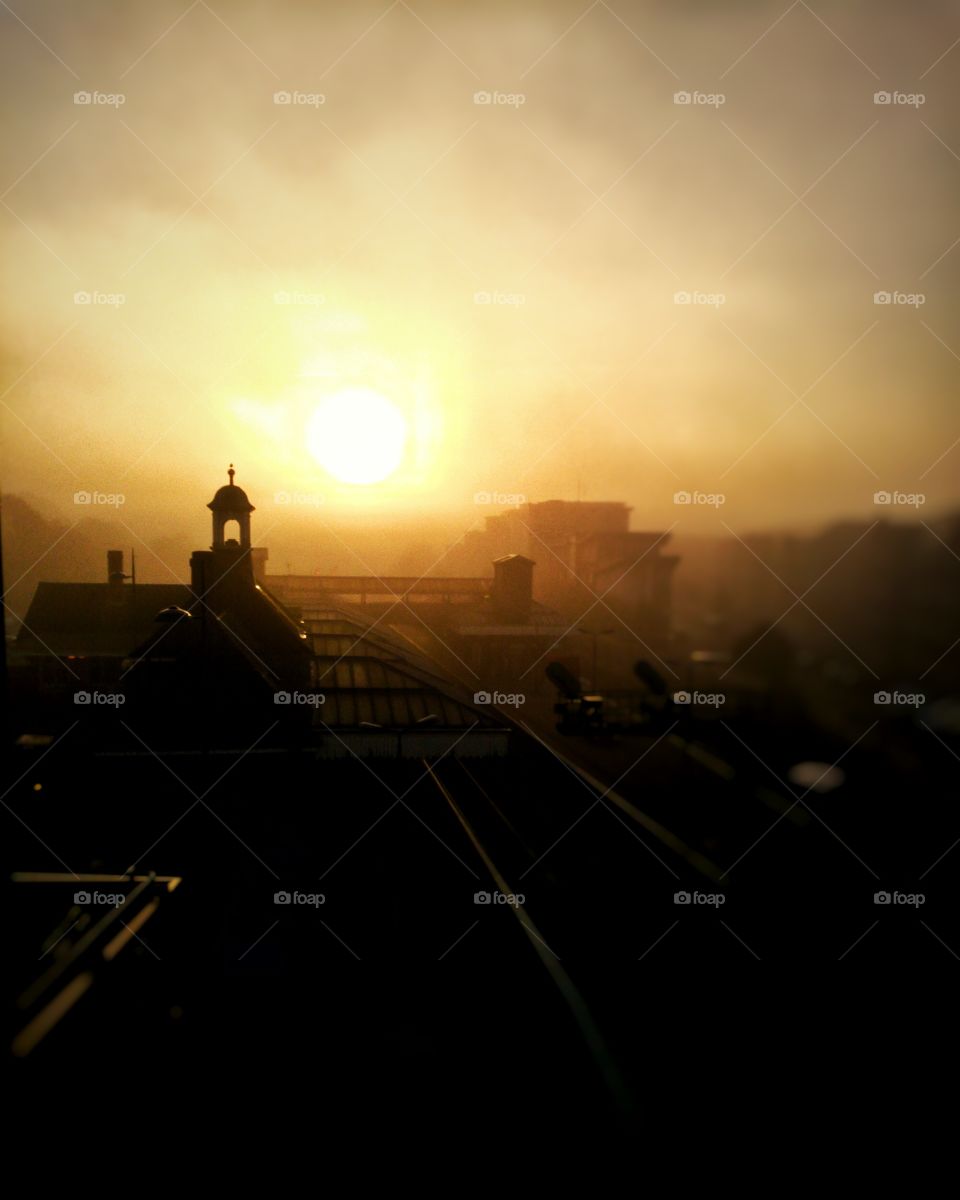 early morning fog casts a creepy silhouette over the train station