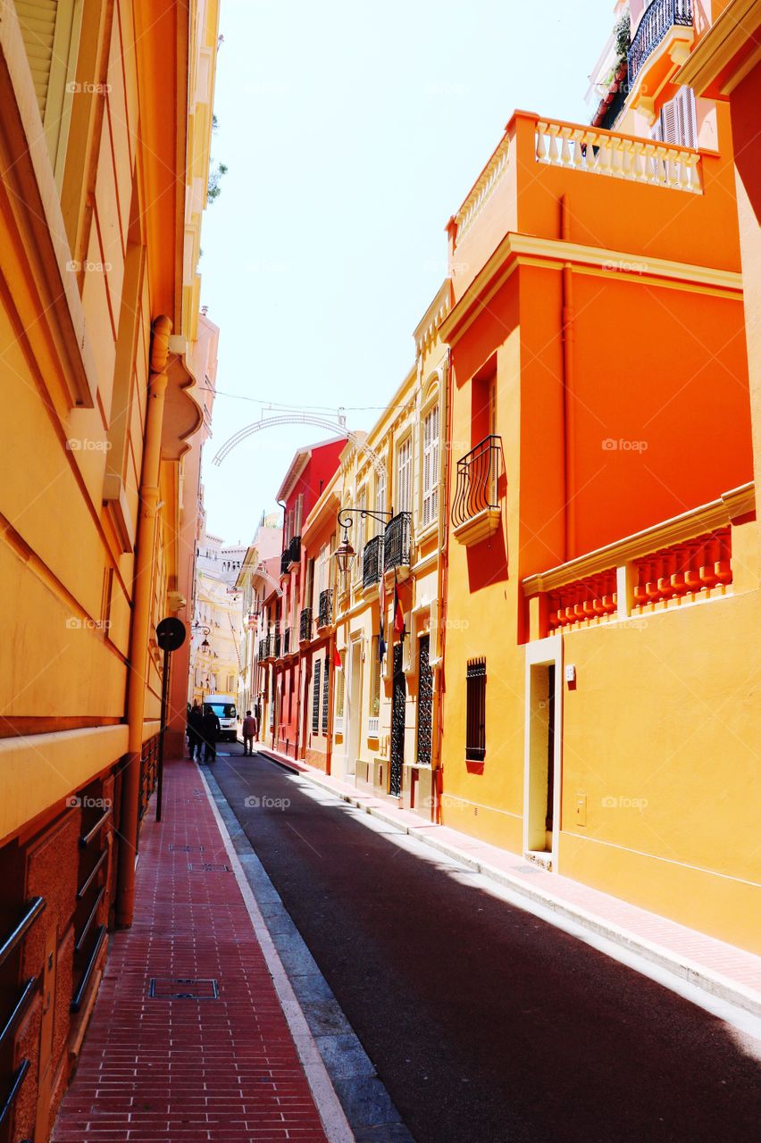 Bright coloured buildings on the both sides of a narrow road