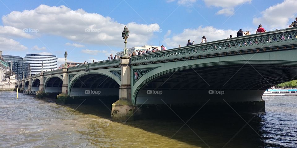side on shot of Westminster Bridge in London on sunny day