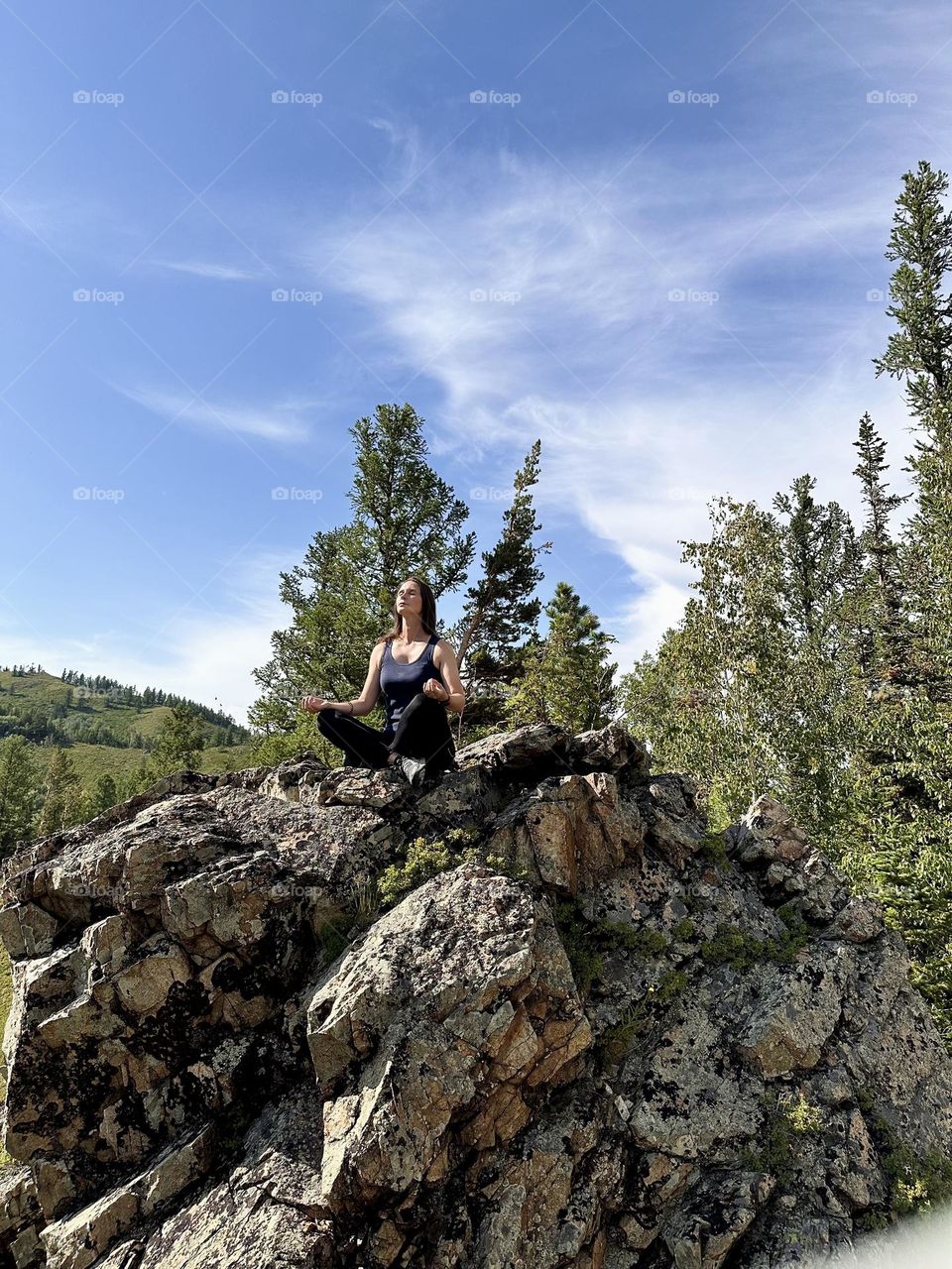 girl meditating on a rock