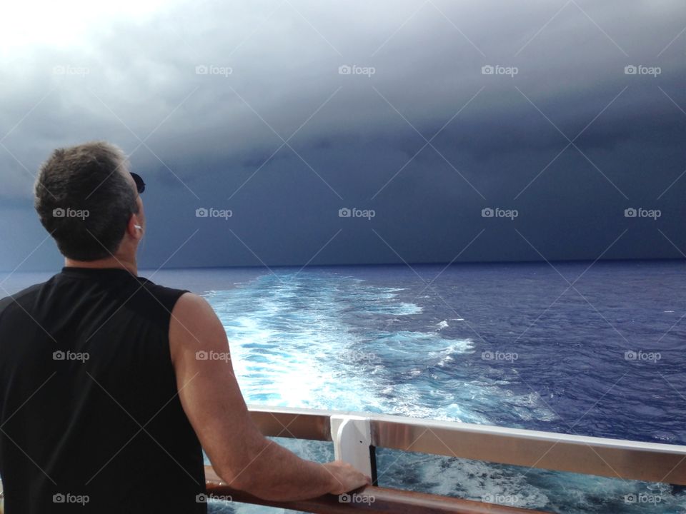 Rear view of a man standing at sea side