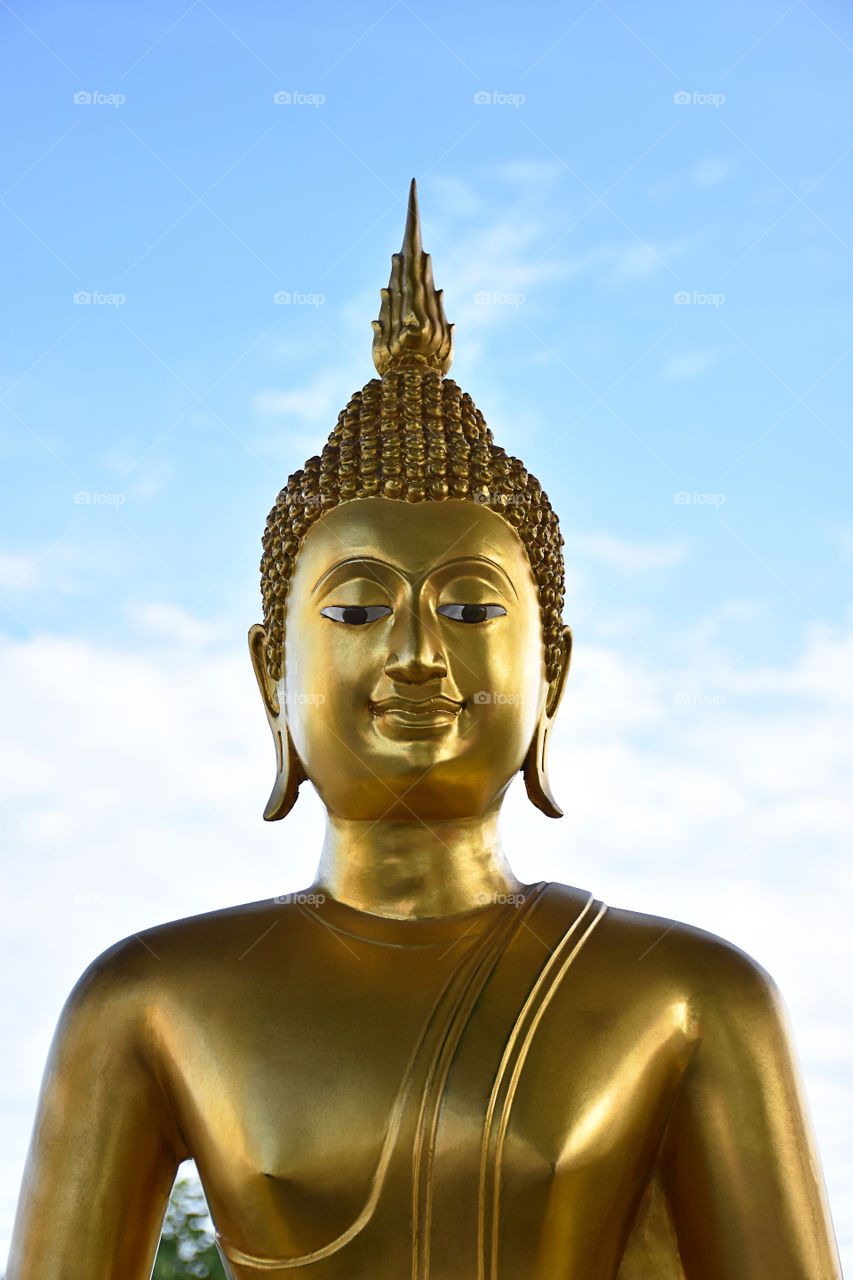 Face of buddha statue and sky , Thailand.