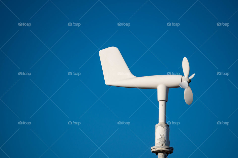 Closeup of wind turbine against clear sky