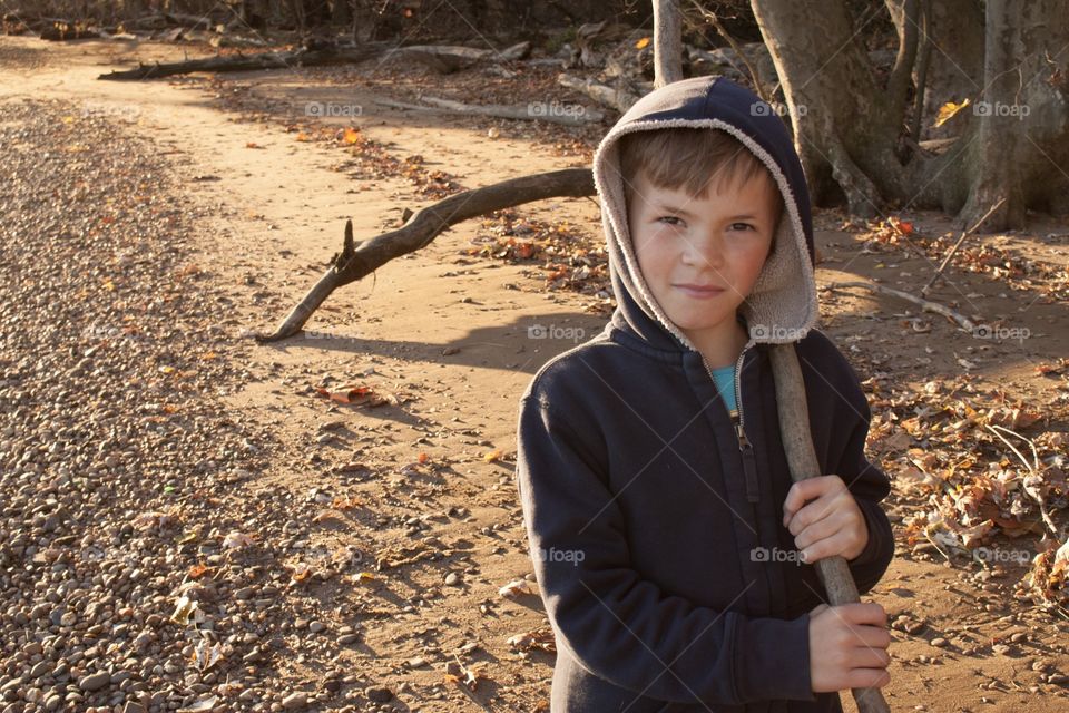 Boy with hoodie by the river