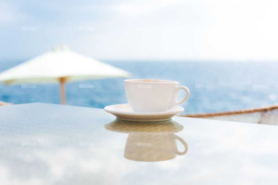 View of coffee cup on tablet at morning