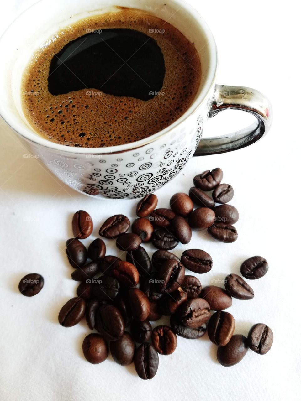 Coffee team, cup of coffee and coffee beans on a white background