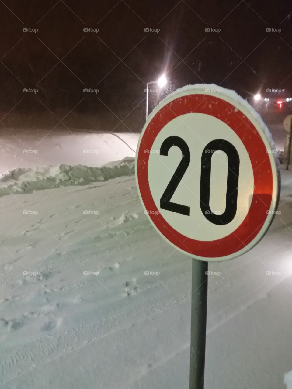 Limited speed sign.Snow behind