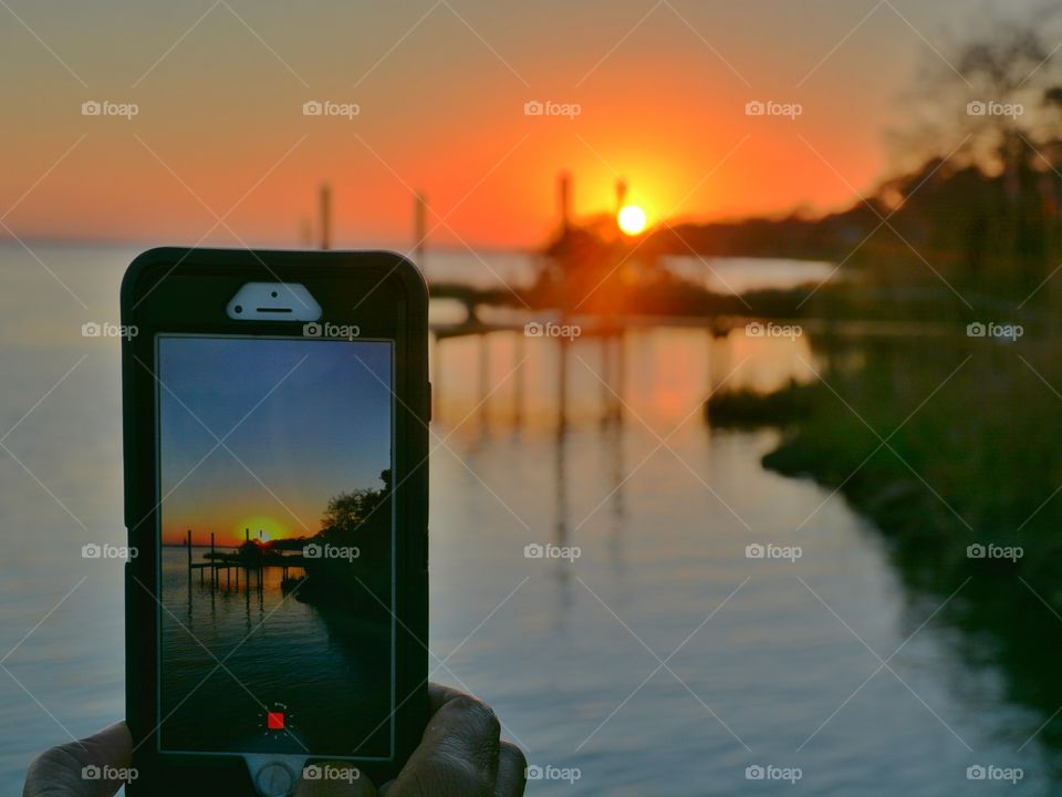 Photographer in action taking a photograph of a magnificent sunset! 