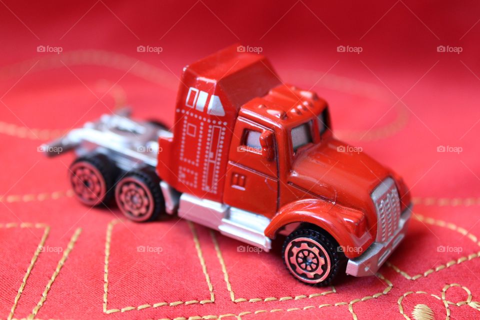 Miniature Coca cola red toy truck on a red background
