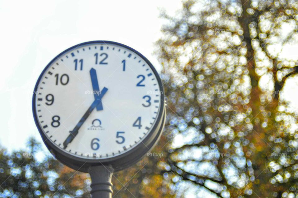 Street clock at autumn