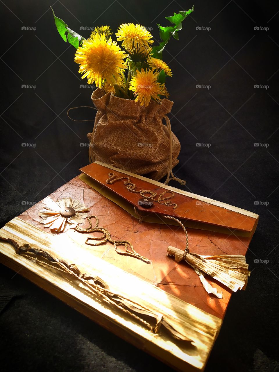 Colors of the spring sun.  Book and a bouquet of dandelions.