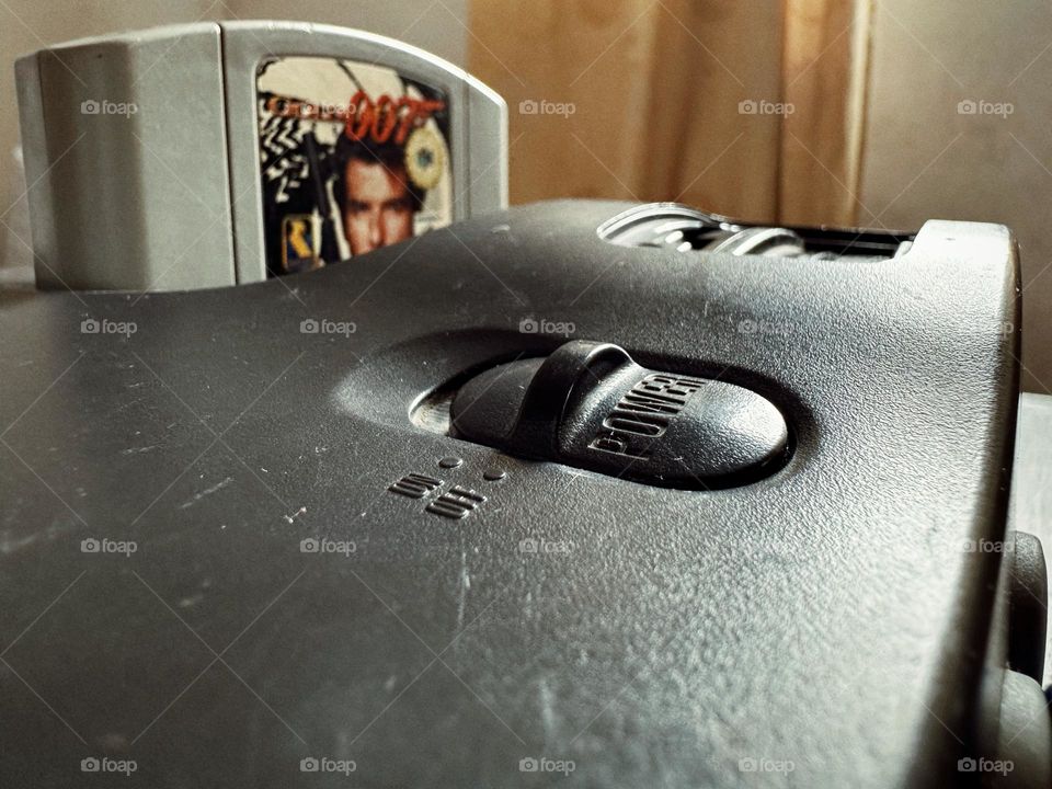 Old Nintendo 64 console closed up with an oldie Videogame cassette ready to be played.