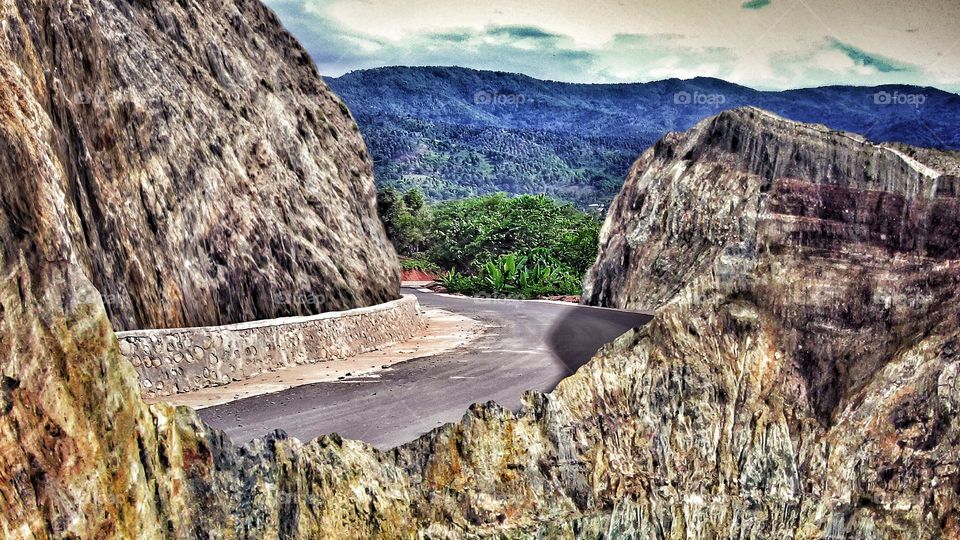 Nature landscape, highway between rock cliffs in hilly area.