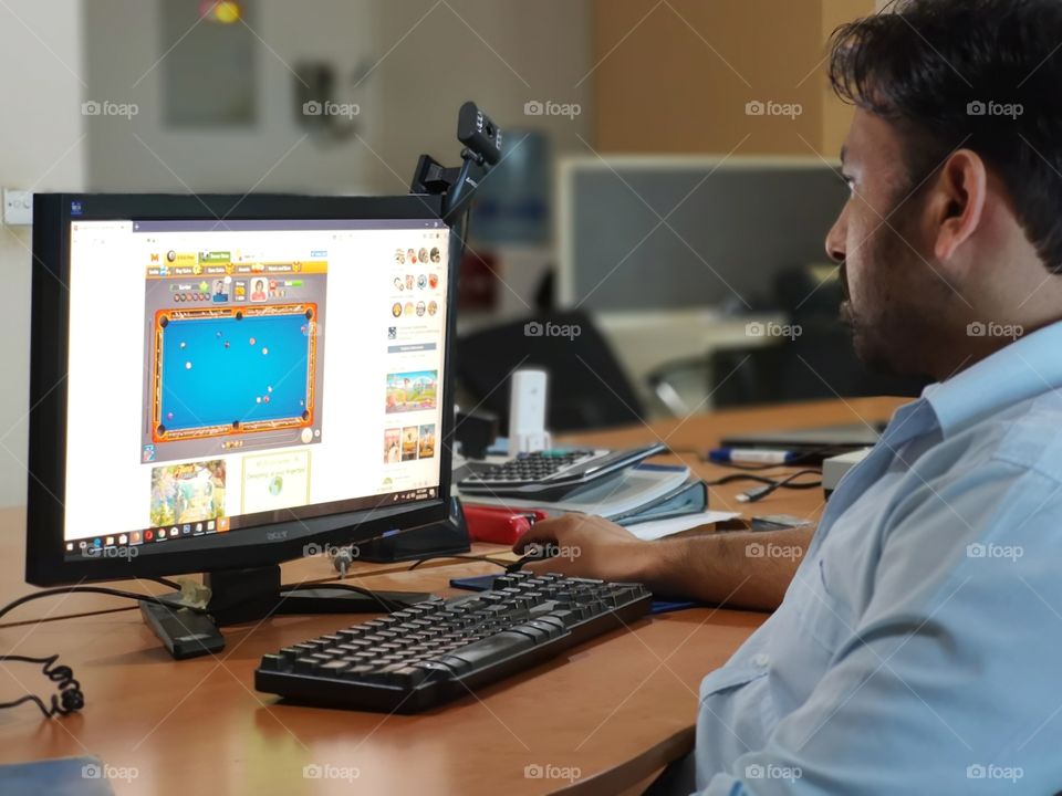 an office employee in front of his computer screen.