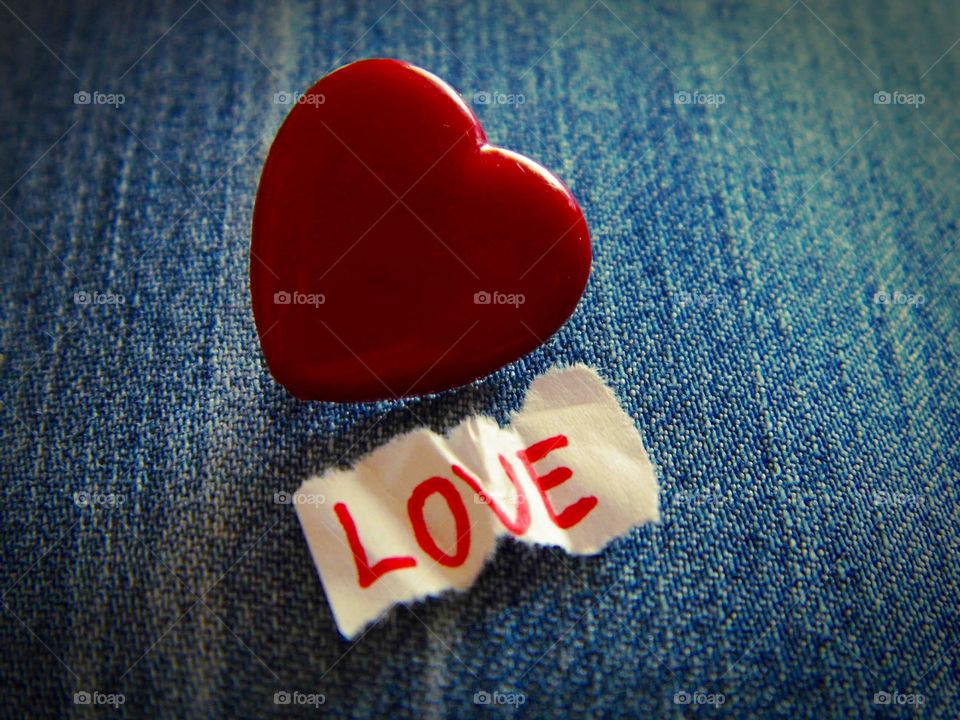 Red heart shape and love text on paper