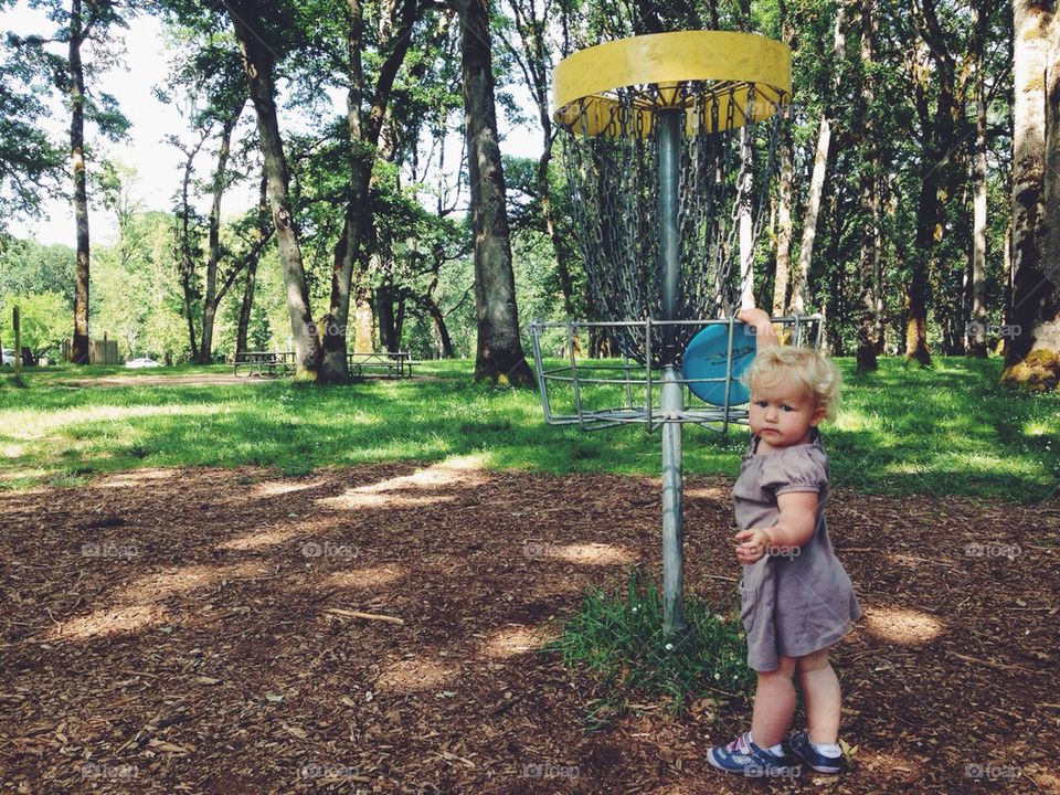 Cute Little Girl Playing Disc Golf