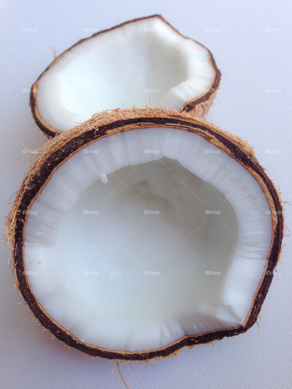 Halved coconut on white background