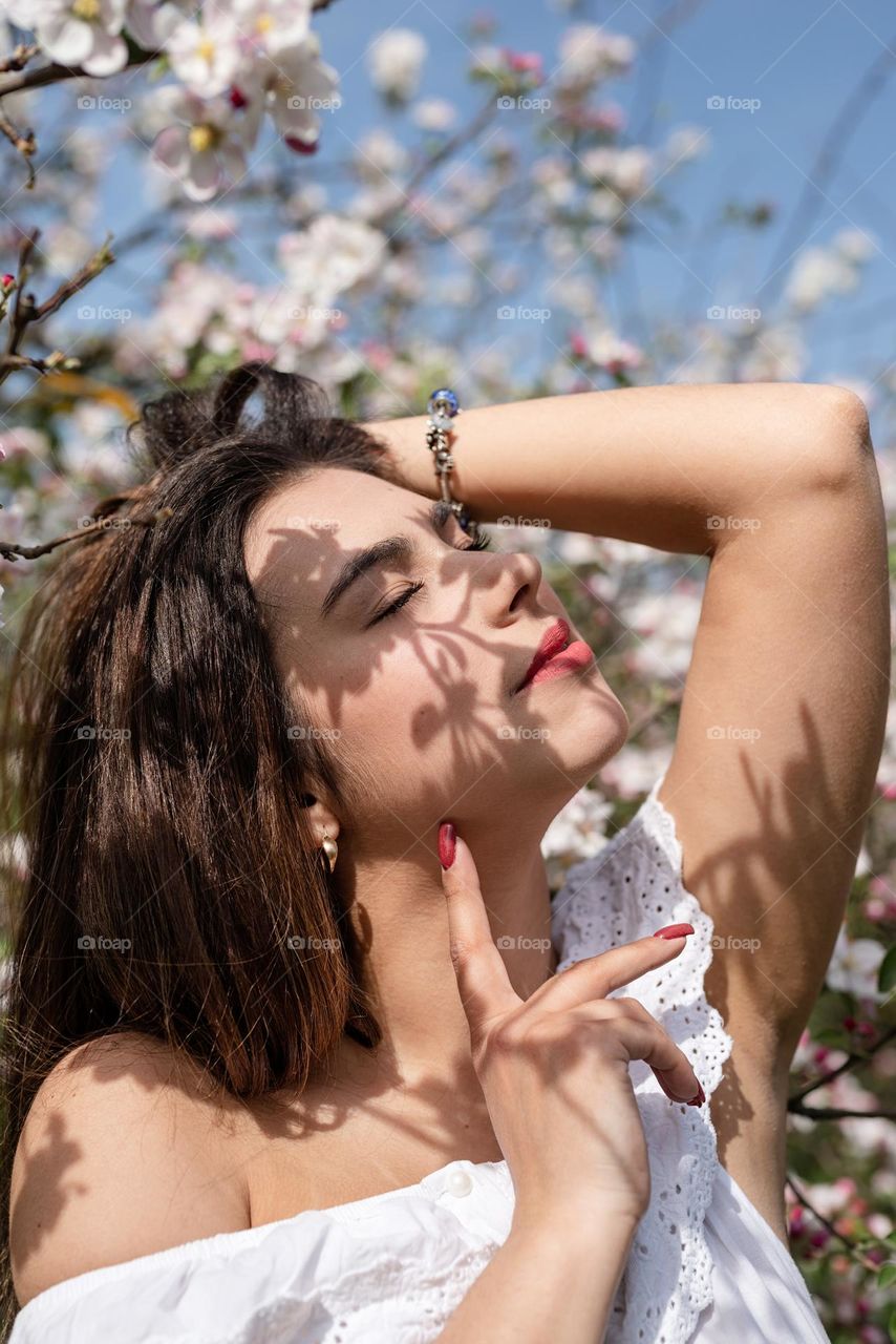 beautiful woman in spring blossom trees