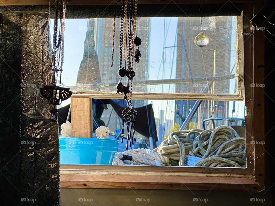 This is the view from our “28 ft 1969 Luhrs”, the boat we call home out onto “Newtown Creek” by the “Pulaski Bridge” in LIC, Queens and neighboring boats on a late afternoon in October 2023. The sun is just beginning to set. Hypnotic Productions