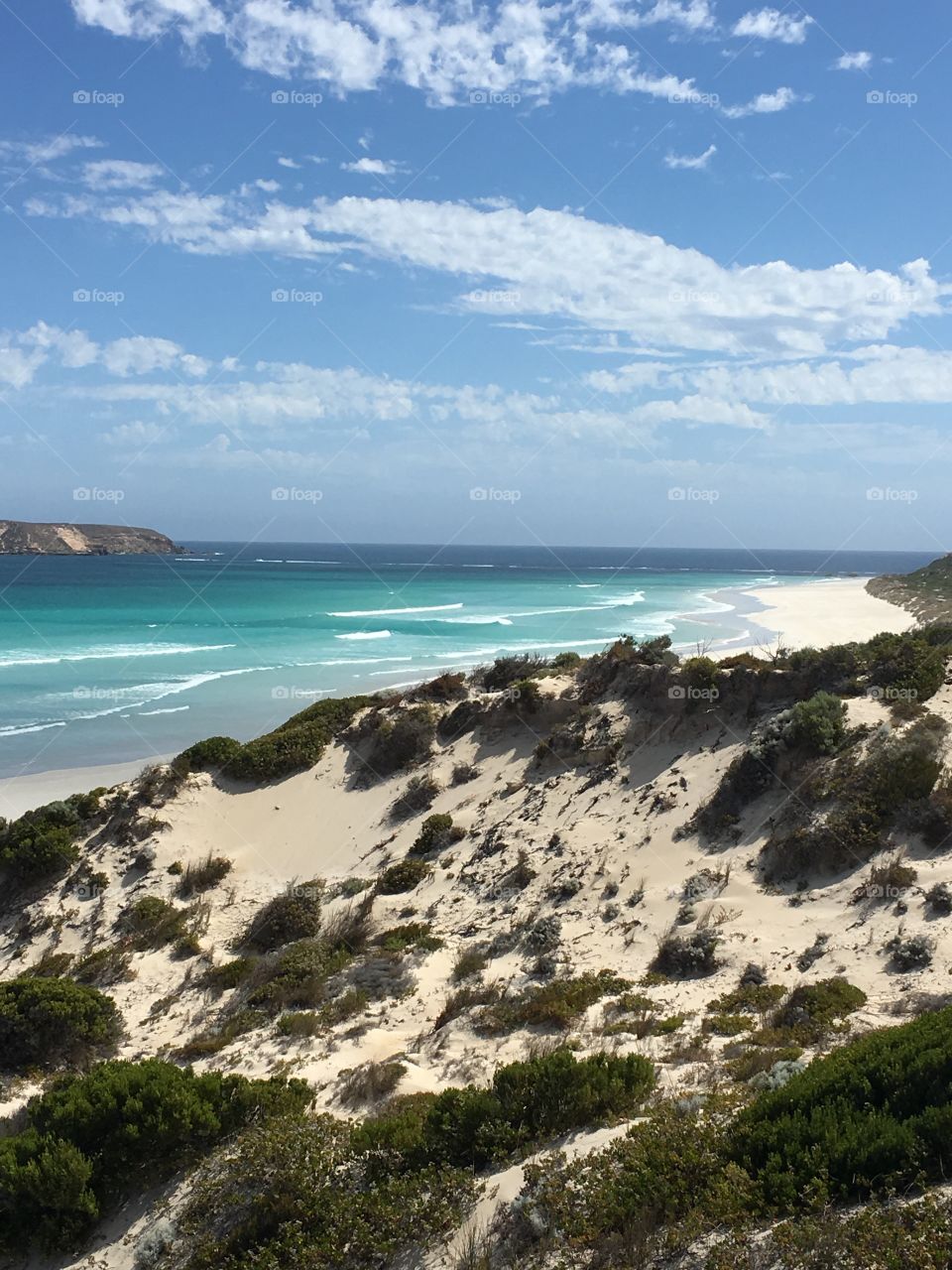 Sand dunes flank this gorgeous remote Aqua turquoise blue coastline in south Australia near Coffin Bay 