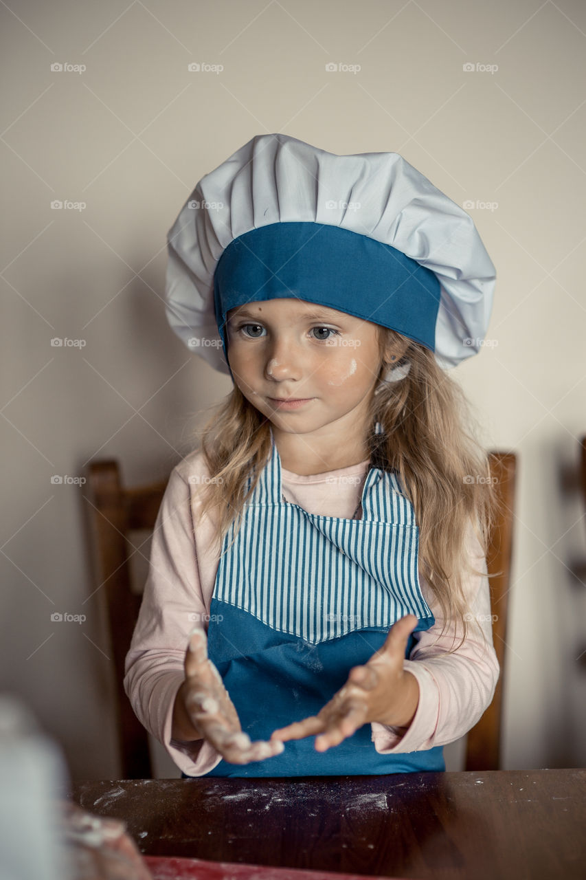 Little sisters cooking the biscuits 