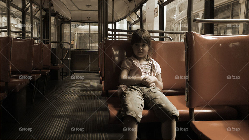 Little girl in the dark tram