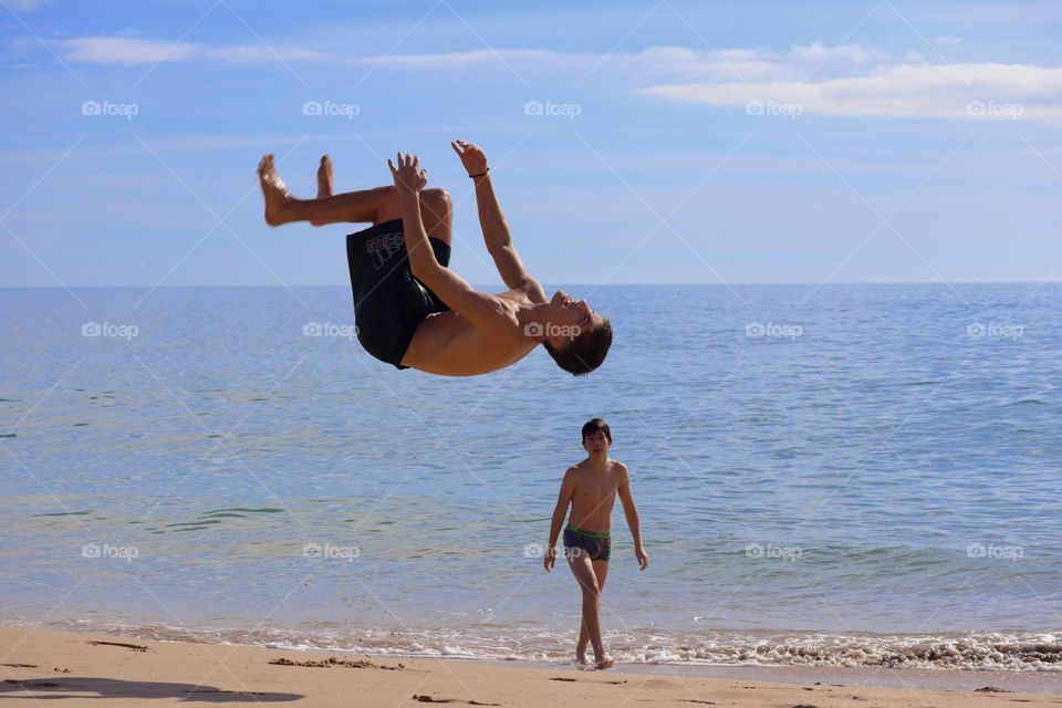 Flipping high on the beach