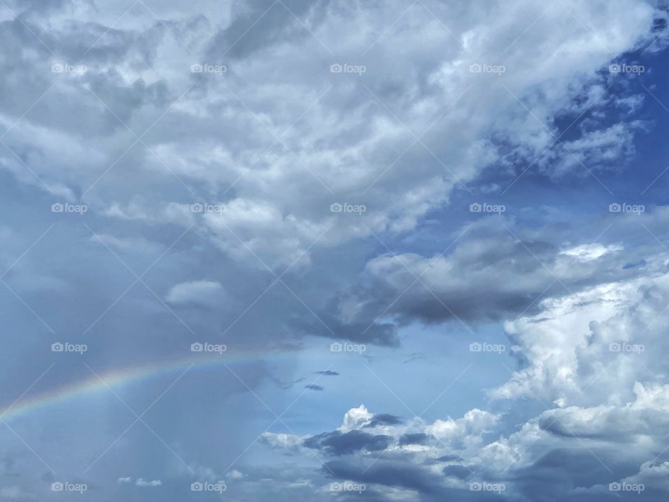 Rain clouds and rainbow