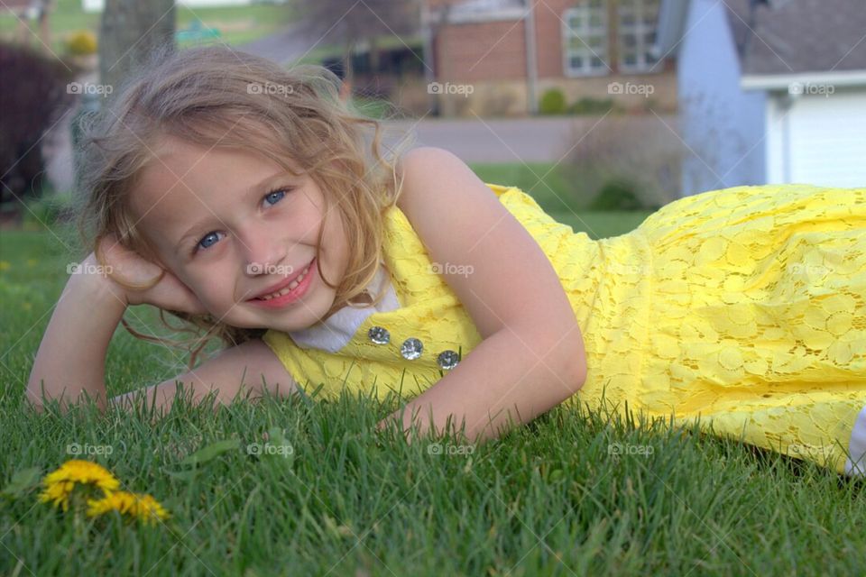 Cute little girl lying in grass
